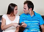Young Couple Fighting For A Tv Pilot Stock Photo