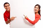 Young Couple Pointing Stock Photo