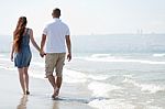Young Couple Walk At The Beach Stock Photo