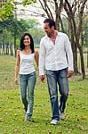 Young Couples Walk Hand In Hand Stock Photo