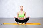 Young Fitness Woman Doing Yoga Exercises Sitting In Lotus Positi Stock Photo