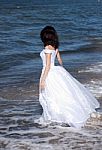 Young Girl In White Dress On The Seashore Stock Photo