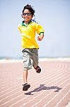 Young Kid Running On Race Track