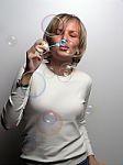Young Lady Blowing Bubbles Stock Photo