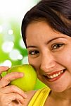 Young Lady Holding An Apple Stock Photo