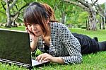 Young Lady With Laptop In Nature Stock Photo