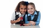 Young Little School Girls With Microscope Stock Photo