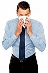 Young Man Having Severe Cold. Sneezing Stock Photo