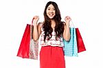 Young Shopaholic Girl With Vibrant Bags Stock Photo