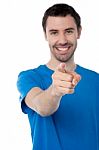 Young Smiling Guy Pointing You Out Stock Photo