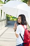 Young Woman Holding A White Umbrella Stock Photo