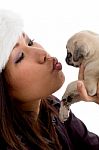 Young Woman kissing her Puppy Stock Photo
