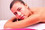 Young Woman Laying On Massage Bed Stock Photo