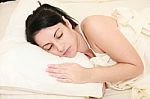 Young Woman Sleeping On Bed Stock Photo