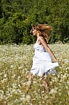 Young woman walking in meadow Stock Photo