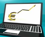 Euro Sign And Up Arrow On Computer For Earnings Or Profit Stock Photo