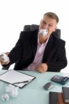 Frustrated Businessman eating Paper Stock Photo