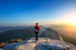 Woman Stands On The Peak Of Stone In Bukhansan National Park,seoul In South Korea And Watching To Sunrise. Beautiful Moment The Miracle Of Nature Stock Photo