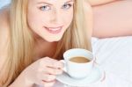 Woman Drinking Coffee In Bed Stock Photo