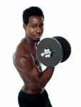 African Guy Lifting Dumbbells Stock Photo