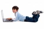 Young Boy Surfing On His Laptop Stock Photo