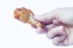Hand Holding Grilled Chicken Wing Isolated On White Background Stock Photo