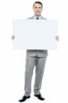 Successful Business Executive Holding Blank Ad Board Stock Photo