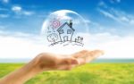 Real-estate Bubble On The Hand Stock Photo