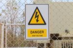 Danger High Voltage Sign On A Fence Stock Photo