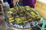 Marinate Fish In Banana Leaf On The Grill Stock Photo