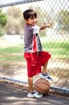 Smart Kid Posing With Basketball Stock Photo