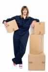 Charming Woman In Uniform Posing With Cartons Stock Photo
