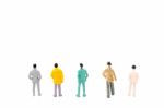 Group Of Miniature People Standing On White Background Stock Photo