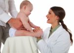Happy Pediatrician Checking Baby Being Held By Father Stock Photo