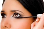 Portrait Of Beautician Applying Maskara On Woman's Eye Stock Photo