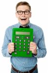 Young Nerd Showing Big Green Calculator Stock Photo