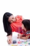 Mother With Child Girl Draw And Paint Together, On White Background Stock Photo