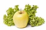 Yellow Apple With Lettuce On White Stock Photo