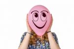 Girl Holding Pink Balloon With Smiling Face Stock Photo