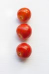 Three Red  Tomatoes On A White  Stock Photo