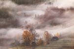 Mountain Village In Clouds Of Fog And Smoke In The Autumn Mornin Stock Photo
