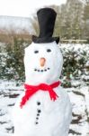 Snowman Wearing Black Hat And Shawl Stock Photo