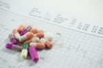 Heap Of Medicine Pills On Cardiogram Grid Paper. Selective Focus Stock Photo