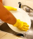 Washing Plates As Part Of The House Work Stock Photo