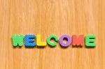 Welcome Letters Fixed On Wooden Board  Stock Photo