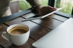 Coffee, Laptop And Notepad On Table In Cafe Stock Photo