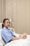 Girl Lying On Patient Bed On Hospital Treatment Room Waiting For Stock Photo
