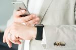 Businessman Using The Apple Watch And An Apple Iphone 6 Stock Photo