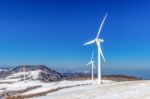 Wind Turbine And Blue Sky In Winter Landscape Stock Photo