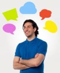Confident Young Man With Speech Bubbles Stock Photo